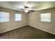 Neutral bedroom featuring three windows and a ceiling fan at 3191 Gay Dr, Decatur, GA 30032