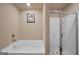 Cozy bathroom featuring a soaking tub and separate glass-enclosed shower at 157 Oliver Dr, Locust Grove, GA 30248