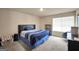 Relaxing bedroom with a comfortable bed, a window letting in lots of light, and a cozy chair at 157 Oliver Dr, Locust Grove, GA 30248