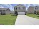 Two story home with a gray exterior, white garage door, and landscaped yard at 157 Oliver Dr, Locust Grove, GA 30248