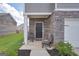Cozy covered front porch with seating and stone accents by the front door at 157 Oliver Dr, Locust Grove, GA 30248