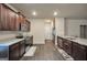 Kitchen with dark cabinets, stainless appliances, and granite countertops at 157 Oliver Dr, Locust Grove, GA 30248