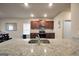 Spacious kitchen featuring granite countertops, a stainless steel sink, and warm wood cabinets at 157 Oliver Dr, Locust Grove, GA 30248