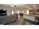 Open-concept living space with hardwood floors, a kitchen island, and dining area at 157 Oliver Dr, Locust Grove, GA 30248