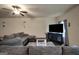 Inviting living room featuring a comfortable gray sectional and modern ceiling fan with light at 157 Oliver Dr, Locust Grove, GA 30248