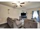 Inviting living room featuring a ceiling fan, neutral walls, and comfortable seating at 157 Oliver Dr, Locust Grove, GA 30248