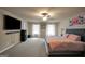 Spacious main bedroom with a plush king bed and large windows allowing natural light at 157 Oliver Dr, Locust Grove, GA 30248