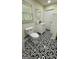 Stylish bathroom featuring a black and white tile floor, vanity, and natural light at 1093 Grace Sw St, Mableton, GA 30126