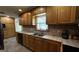 Functional kitchen featuring wood cabinets, tile countertops, and stainless steel double sink at 1093 Grace Sw St, Mableton, GA 30126