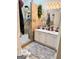 Bathroom featuring double sinks, a walk-in shower, and neutral decor at 110 S Fairfield Dr, Peachtree City, GA 30269