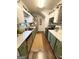 Galley kitchen featuring sleek countertops, stainless steel appliances, and modern fixtures at 110 S Fairfield Dr, Peachtree City, GA 30269