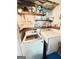 Functional laundry room with modern washer and dryer, shelving, and tiled backsplash at 110 S Fairfield Dr, Peachtree City, GA 30269