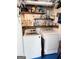 Bright laundry room featuring a modern washer and dryer, and ample shelving at 110 S Fairfield Dr, Peachtree City, GA 30269