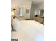 Well-lit main bedroom featuring neutral tones, ensuite access, and dresser at 110 S Fairfield Dr, Peachtree City, GA 30269