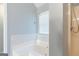 Bathroom showcases a large soaking tub with shower combo next to window for relaxing baths at 2554 Willenhall Way, Lithonia, GA 30058