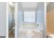 Bathroom featuring a wide soaking tub, window, and separate toilet room at 2554 Willenhall Way, Lithonia, GA 30058