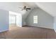 Spacious bedroom featuring neutral-toned walls, carpeted floors, and a ceiling fan at 2554 Willenhall Way, Lithonia, GA 30058