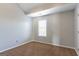 Cozy bedroom with neutral walls, carpeted floors, and a large window at 2554 Willenhall Way, Lithonia, GA 30058