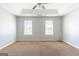 Large bedroom with natural light, carpeted floors, and a tray ceiling with fan at 2554 Willenhall Way, Lithonia, GA 30058