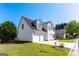 Charming two-story home with white siding, black roof, and well-manicured landscaping at 2554 Willenhall Way, Lithonia, GA 30058