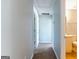 Hallway view leading to a bathroom with carpet flooring and neutral paint at 2554 Willenhall Way, Lithonia, GA 30058