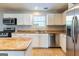 Well-lit kitchen featuring stainless steel appliances, countertops, and white cabinetry at 2554 Willenhall Way, Lithonia, GA 30058
