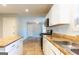 Open kitchen layout leading into a living area with stainless steel appliances at 2554 Willenhall Way, Lithonia, GA 30058