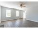 Bright living room features hardwood floors, ceiling fan, and large windows at 2554 Willenhall Way, Lithonia, GA 30058