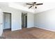 Spacious bedroom with neutral walls, carpet floors, and a ceiling fan with lighting fixture at 2554 Willenhall Way, Lithonia, GA 30058