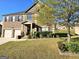 Beautiful two-story brick home with a two car garage and a well-manicured lawn in a suburban neighborhood at 1166 Vienna Ct, Hampton, GA 30228