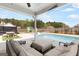 Relaxing outdoor living with pool, patio seating and dining, and covered outdoor kitchen at 155 Lawrence Dr, Villa Rica, GA 30180