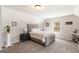 Bright bedroom with a plush upholstered bed frame and a neutral color palette at 155 Lawrence Dr, Villa Rica, GA 30180