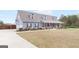 Charming two-story home boasts a spacious front yard and inviting covered porch at 155 Lawrence Dr, Villa Rica, GA 30180