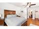 Cozy main bedroom featuring hardwood floors, ceiling fan, and ensuite bathroom at 155 Lawrence Dr, Villa Rica, GA 30180