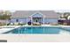Inviting backyard pool and patio with lounge area and well-manicured landscaping at 155 Lawrence Dr, Villa Rica, GA 30180