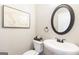 Classic powder room features a pedestal sink, round mirror, and elegant decor for guests at 155 Lawrence Dr, Villa Rica, GA 30180