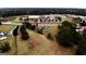 Aerial view of the property near schools and roads, surrounded by lush greenery and open fields at 5300 Salem Rd, Covington, GA 30016