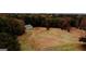 Aerial view of barn surrounded by trees and a grass field on the property at 5300 Salem Rd, Covington, GA 30016