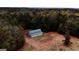 Aerial view of barn surrounded by trees and a grass field on the property at 5300 Salem Rd, Covington, GA 30016
