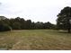 A large, grass-covered land lot surrounded by trees, offering privacy and natural beauty at 5300 Salem Rd, Covington, GA 30016