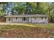 Charming single-story home with a gray brick facade and a well-maintained front yard at 3456 Glensford Dr, Decatur, GA 30032
