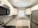 Bright kitchen with new stainless appliances, granite countertops, and white cabinets at 3456 Glensford Dr, Decatur, GA 30032
