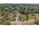 Aerial view showcases lakefront properties with manicured lawns, a lake, and mature trees at 115 W Wind Ct, Tyrone, GA 30290