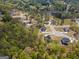 Aerial view showcases a neighborhood with a lake, mature trees and large lots at 115 W Wind Ct, Tyrone, GA 30290