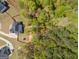 Aerial view highlights home with a fenced backyard, mature trees and play area at 115 W Wind Ct, Tyrone, GA 30290