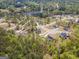 Aerial view showcases a neighborhood with a lake, mature trees and large lots at 115 W Wind Ct, Tyrone, GA 30290