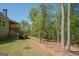 Backyard featuring a deck, and mature trees to provide shade and privacy at 115 W Wind Ct, Tyrone, GA 30290