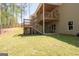 Backyard with spacious multi-level deck, stairways, and play area, providing ample room for outdoor activities at 115 W Wind Ct, Tyrone, GA 30290