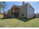 Spacious backyard featuring a multi-level deck and patio, perfect for outdoor entertaining and relaxation at 115 W Wind Ct, Tyrone, GA 30290