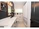 Modern bathroom with a long white countertop and a decorative shower curtain at 115 W Wind Ct, Tyrone, GA 30290